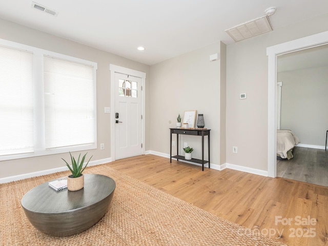 entryway with light wood-style floors, baseboards, and recessed lighting
