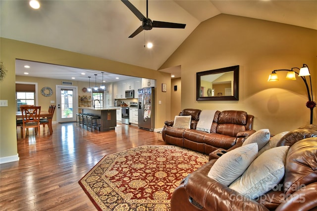 living room featuring a ceiling fan, dark wood-style floors, high vaulted ceiling, and recessed lighting