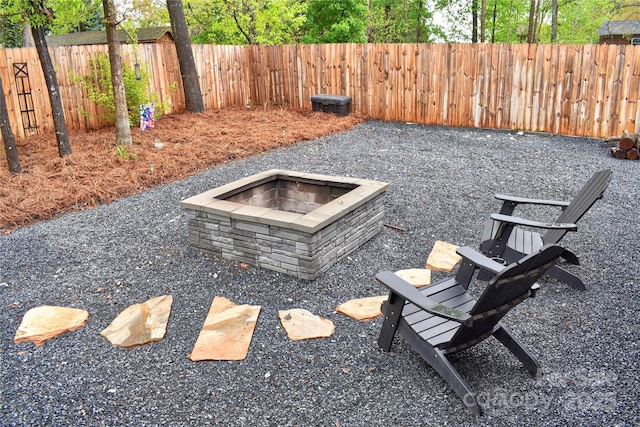 fenced backyard with an outdoor fire pit