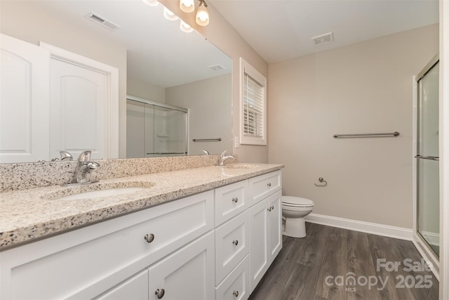 115 Frances St, Salisbury, NC 28147 - full bathroom featuring an enclosed shower, double vanity, and wood finished floors