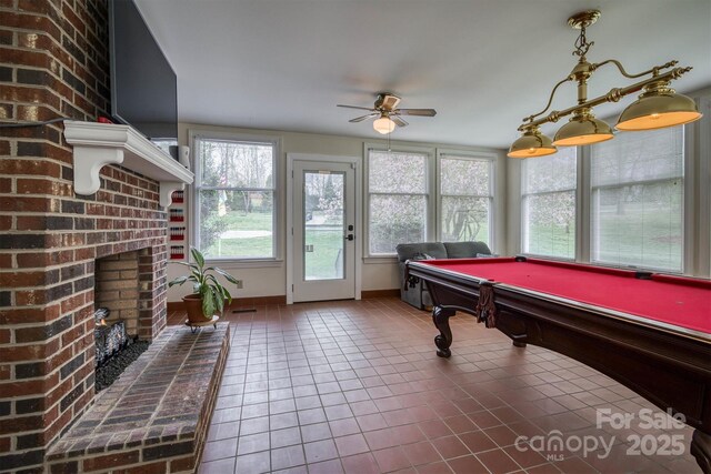 playroom featuring baseboards, billiards, tile patterned floors, a brick fireplace, and ceiling fan
