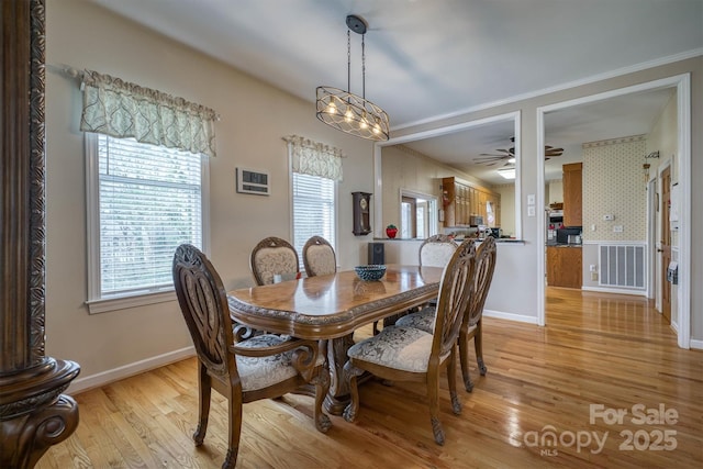 dining area featuring light wood-type flooring, wallpapered walls, ceiling fan, and baseboards