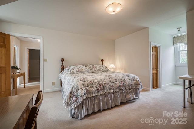 bedroom featuring baseboards and carpet