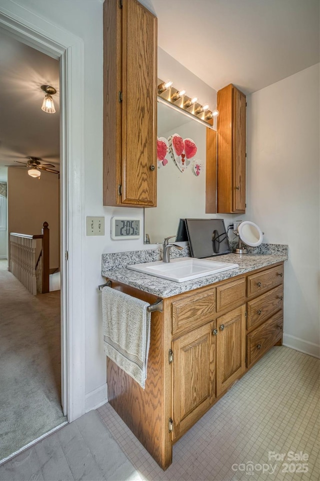 bathroom with vanity, baseboards, and a ceiling fan
