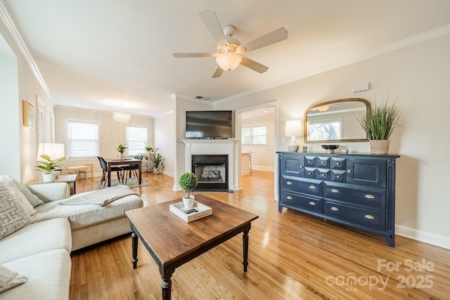 3510 Conway Ave, Charlotte, NC 28209 - living area featuring crown molding, light wood-type flooring, a ceiling fan, baseboards, and a chandelier