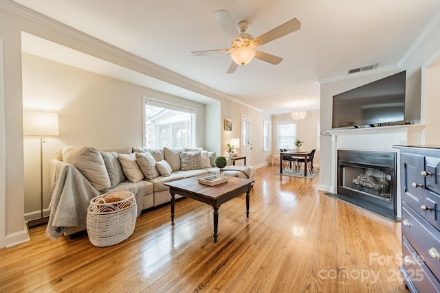 3510 Conway Ave, Charlotte, NC 28209 - living room with crown molding, ceiling fan, light wood-style floors, baseboards, and a fireplace