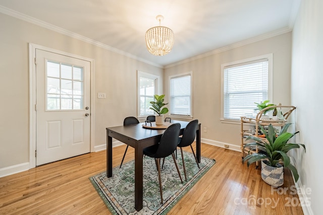 3510 Conway Ave, Charlotte, NC 28209 - dining room with a chandelier, plenty of natural light, light wood-style floors, baseboards, and crown molding