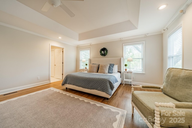 3510 Conway Ave, Charlotte, NC 28209 - bedroom with wood finished floors, a raised ceiling, multiple windows, ceiling fan, and recessed lighting