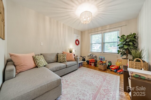 3510 Conway Ave, Charlotte, NC 28209 - living area featuring light wood-type flooring and a chandelier