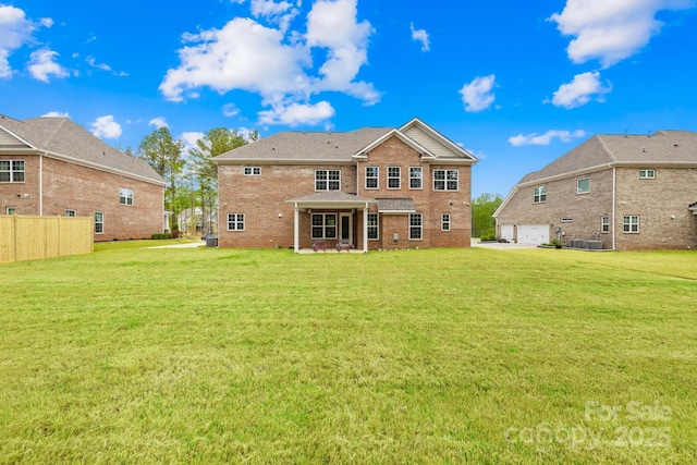 rear view of property featuring central AC, a yard, a garage, fence, and brick siding