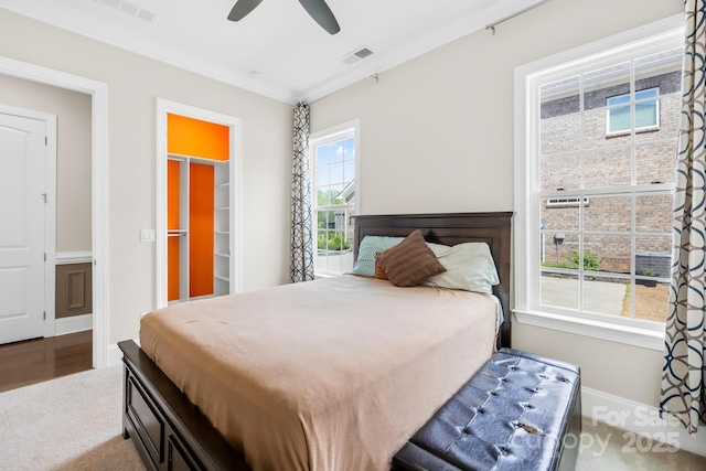 bedroom with a ceiling fan, baseboards, a spacious closet, and visible vents
