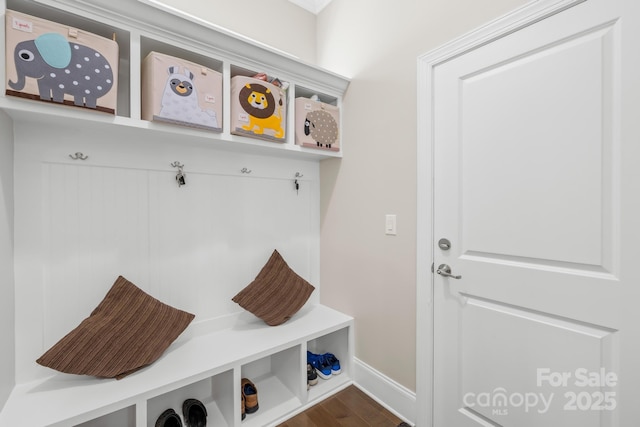 mudroom featuring dark wood-style flooring and baseboards