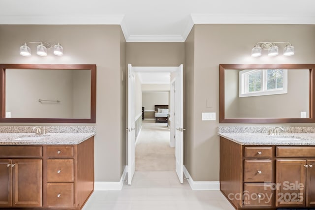 bathroom with two vanities, a sink, and crown molding