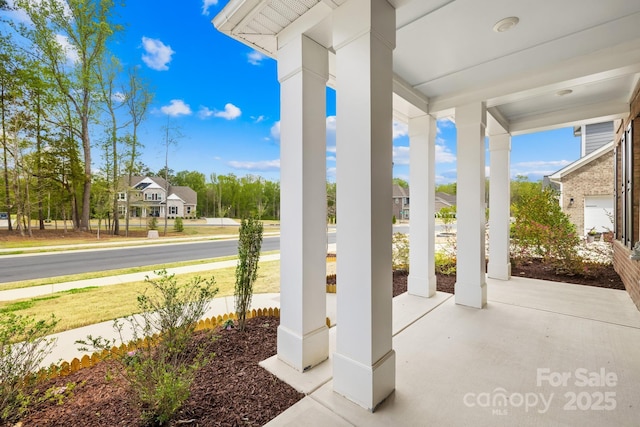 view of patio featuring a porch and a residential view