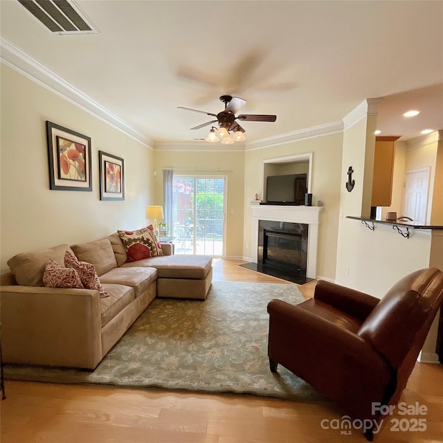 14022 Drake Watch Ln, Charlotte, NC 28262 - living area with wood finished floors, visible vents, ornamental molding, and ceiling fan