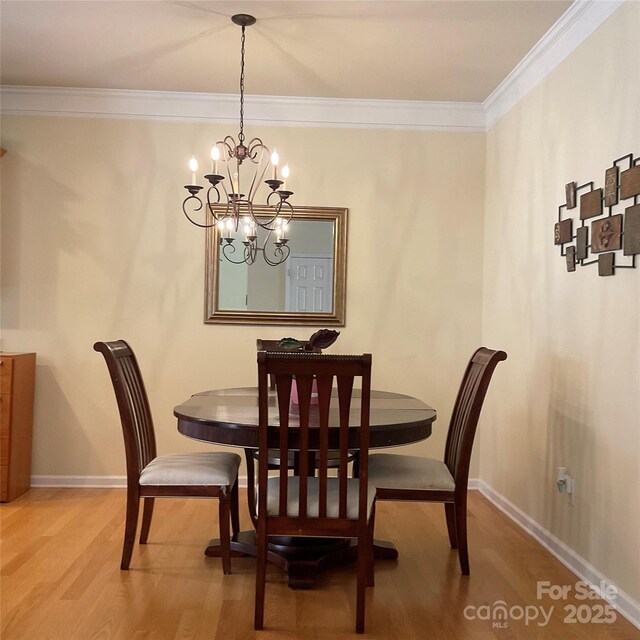 14022 Drake Watch Ln, Charlotte, NC 28262 - dining space featuring ornamental molding, baseboards, an inviting chandelier, and wood finished floors