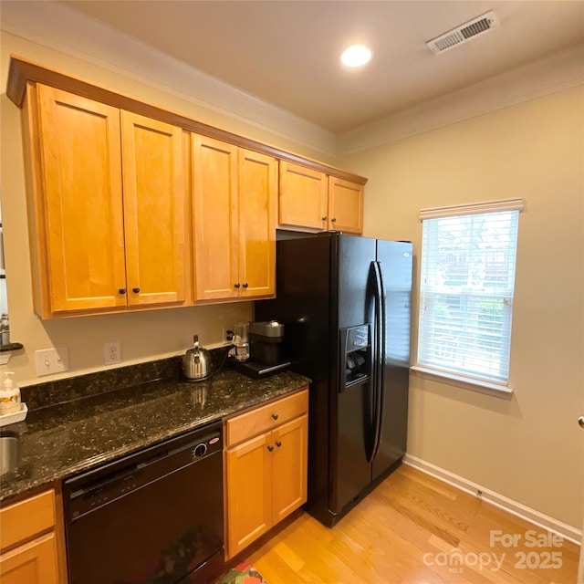 14022 Drake Watch Ln, Charlotte, NC 28262 - kitchen with light wood-style floors, crown molding, visible vents, black appliances, and dark stone countertops