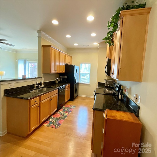 14022 Drake Watch Ln, Charlotte, NC 28262 - kitchen featuring light wood-type flooring, a sink, black appliances, and a healthy amount of sunlight