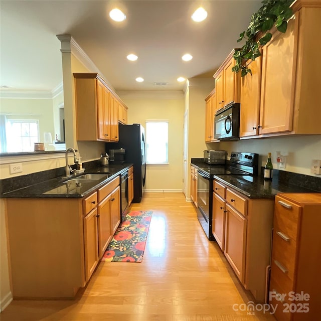 14022 Drake Watch Ln, Charlotte, NC 28262 - kitchen featuring a wealth of natural light, a sink, black appliances, and ornamental molding