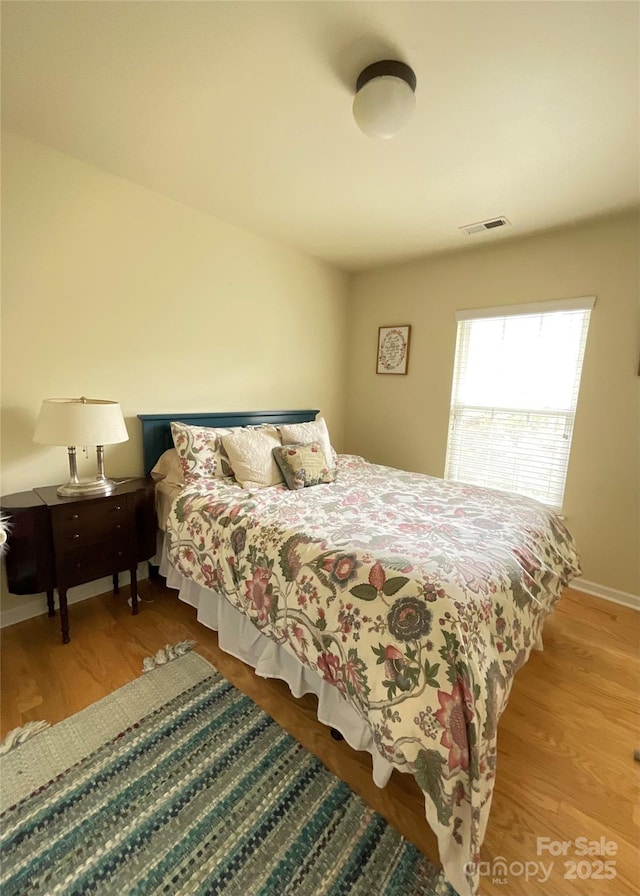 14022 Drake Watch Ln, Charlotte, NC 28262 - bedroom featuring visible vents, baseboards, and wood finished floors