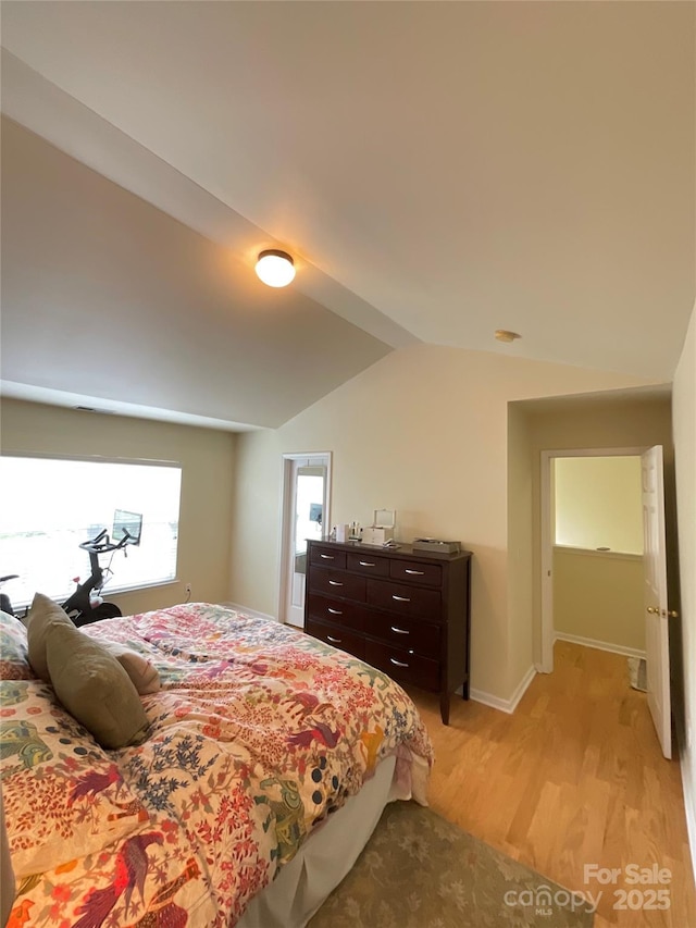 14022 Drake Watch Ln, Charlotte, NC 28262 - bedroom featuring light wood-style flooring, baseboards, and lofted ceiling