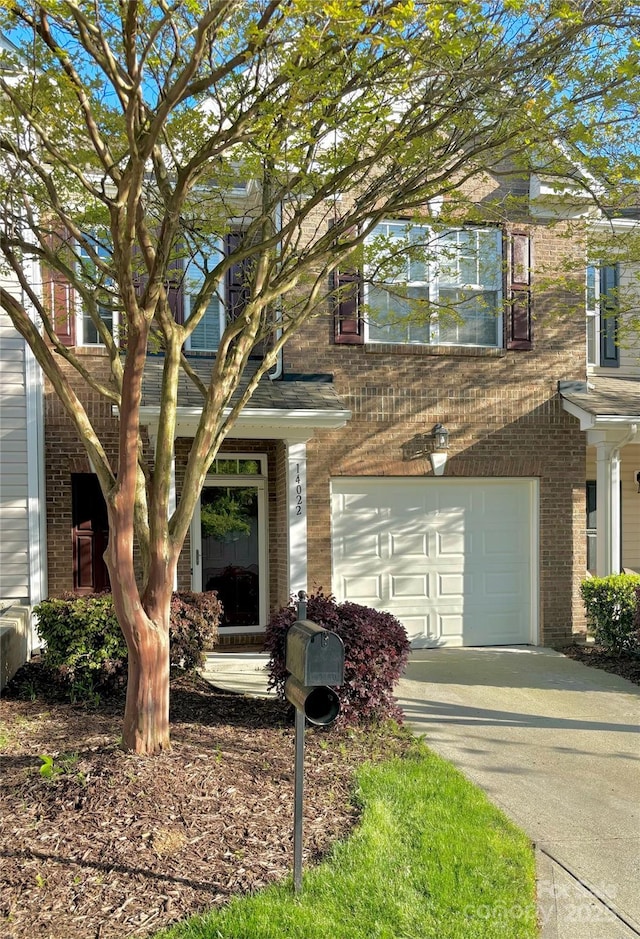 14022 Drake Watch Ln, Charlotte, NC 28262 - view of front facade with brick siding, a garage, and concrete driveway