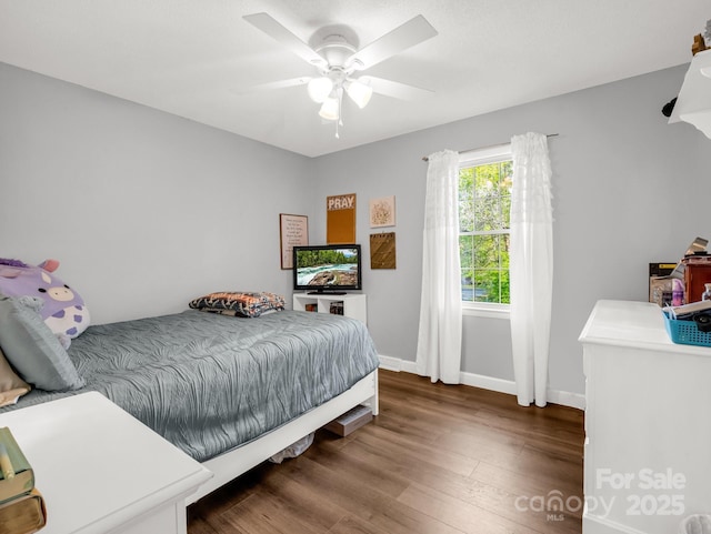 bedroom with baseboards, a ceiling fan, and wood finished floors