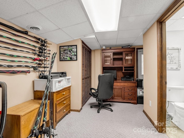 office featuring a paneled ceiling, light colored carpet, and visible vents