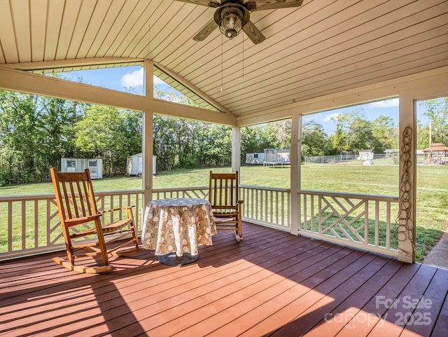 unfurnished sunroom with a ceiling fan