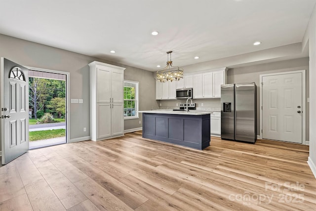 102 Kerda St, Taylorsville, NC 28681 - kitchen with white cabinets, stainless steel appliances, recessed lighting, a notable chandelier, and light countertops