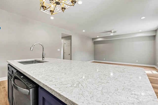 102 Kerda St, Taylorsville, NC 28681 - kitchen with recessed lighting, light stone counters, dishwasher, a sink, and light wood-type flooring