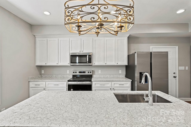102 Kerda St, Taylorsville, NC 28681 - kitchen with appliances with stainless steel finishes, a sink, white cabinetry, and recessed lighting