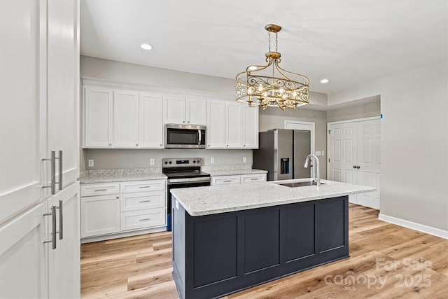 102 Kerda St, Taylorsville, NC 28681 - kitchen featuring stainless steel appliances, a sink, pendant lighting, a kitchen island with sink, and white cabinetry