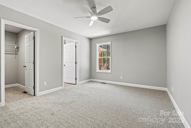 102 Kerda St, Taylorsville, NC 28681 - unfurnished bedroom featuring a walk in closet, visible vents, carpet flooring, and baseboards