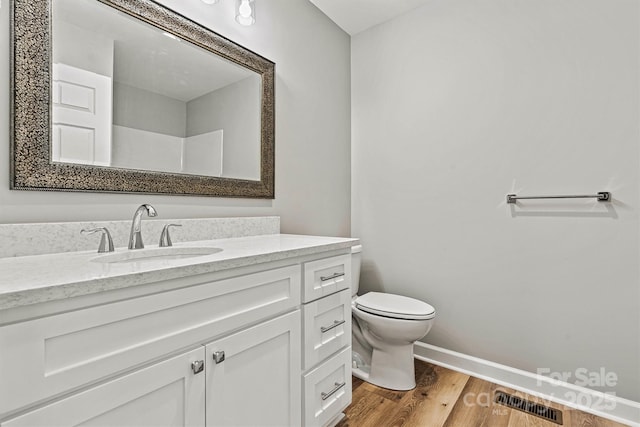 102 Kerda St, Taylorsville, NC 28681 - bathroom featuring wood finished floors, vanity, baseboards, toilet, and visible vents
