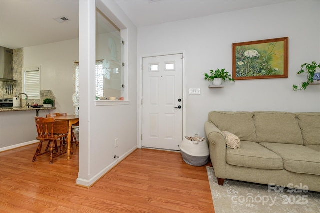 4133 Carl Parmer Dr, Harrisburg, NC 28075 - foyer with visible vents, baseboards, and light wood-style floors