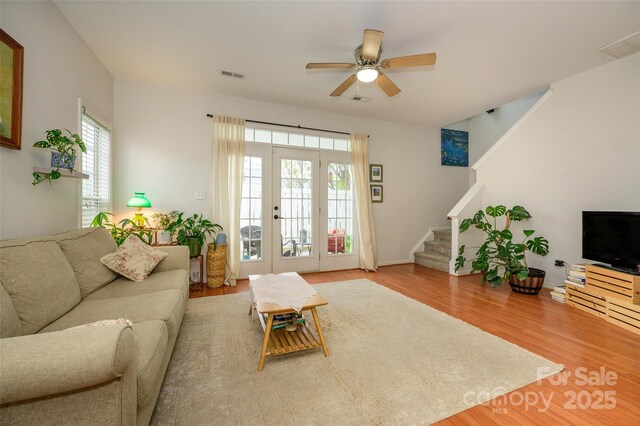 4133 Carl Parmer Dr, Harrisburg, NC 28075 - living area featuring a ceiling fan, visible vents, stairway, wood finished floors, and french doors
