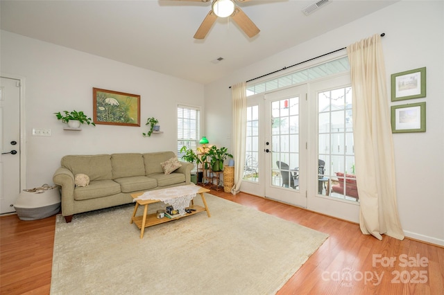 4133 Carl Parmer Dr, Harrisburg, NC 28075 - living area featuring visible vents, light wood-style flooring, and ceiling fan