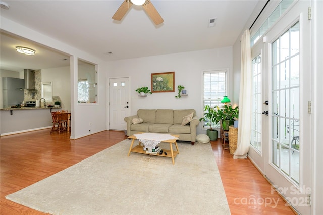 4133 Carl Parmer Dr, Harrisburg, NC 28075 - living area featuring wood finished floors, ceiling fan, and baseboards
