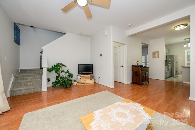 4133 Carl Parmer Dr, Harrisburg, NC 28075 - living room featuring ceiling fan, stairway, wood finished floors, and baseboards