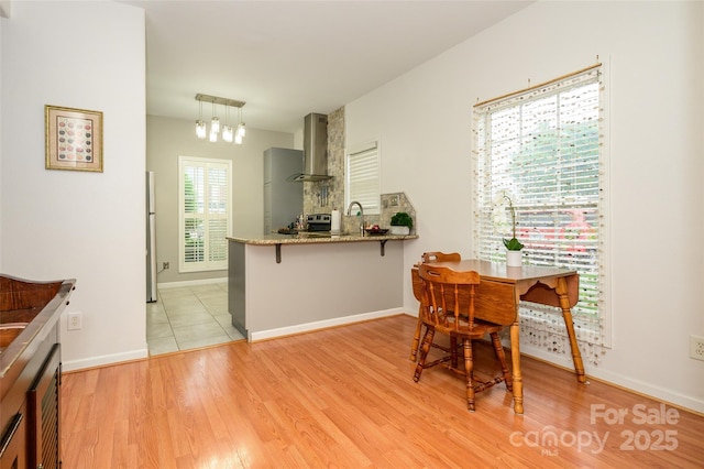 4133 Carl Parmer Dr, Harrisburg, NC 28075 - dining room with light wood-style floors, an inviting chandelier, and baseboards