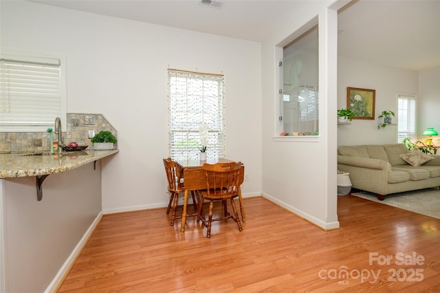 4133 Carl Parmer Dr, Harrisburg, NC 28075 - dining space featuring light wood-style floors, baseboards, and visible vents