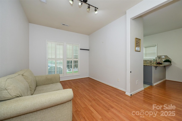 4133 Carl Parmer Dr, Harrisburg, NC 28075 - sitting room with light wood-style floors, visible vents, baseboards, and track lighting