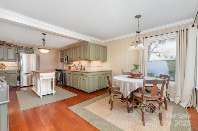 dining space featuring dark wood-type flooring and crown molding