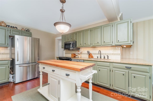 kitchen with a sink, appliances with stainless steel finishes, and green cabinets