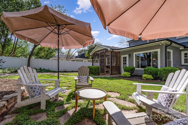 view of yard featuring a sunroom and fence