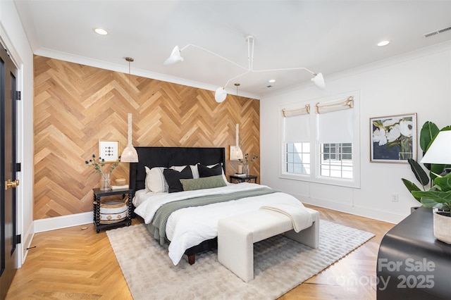 bedroom with an accent wall, ornamental molding, visible vents, recessed lighting, and baseboards