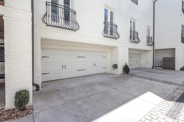garage featuring concrete driveway