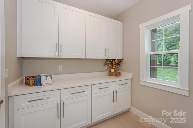 8225 Long Island Rd, Catawba, NC 28609 - kitchen with white cabinetry, light countertops, light wood-style floors, and baseboards