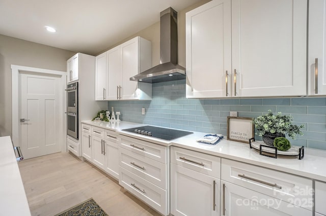 8225 Long Island Rd, Catawba, NC 28609 - kitchen with wall chimney range hood, black electric cooktop, double oven, light countertops, and recessed lighting